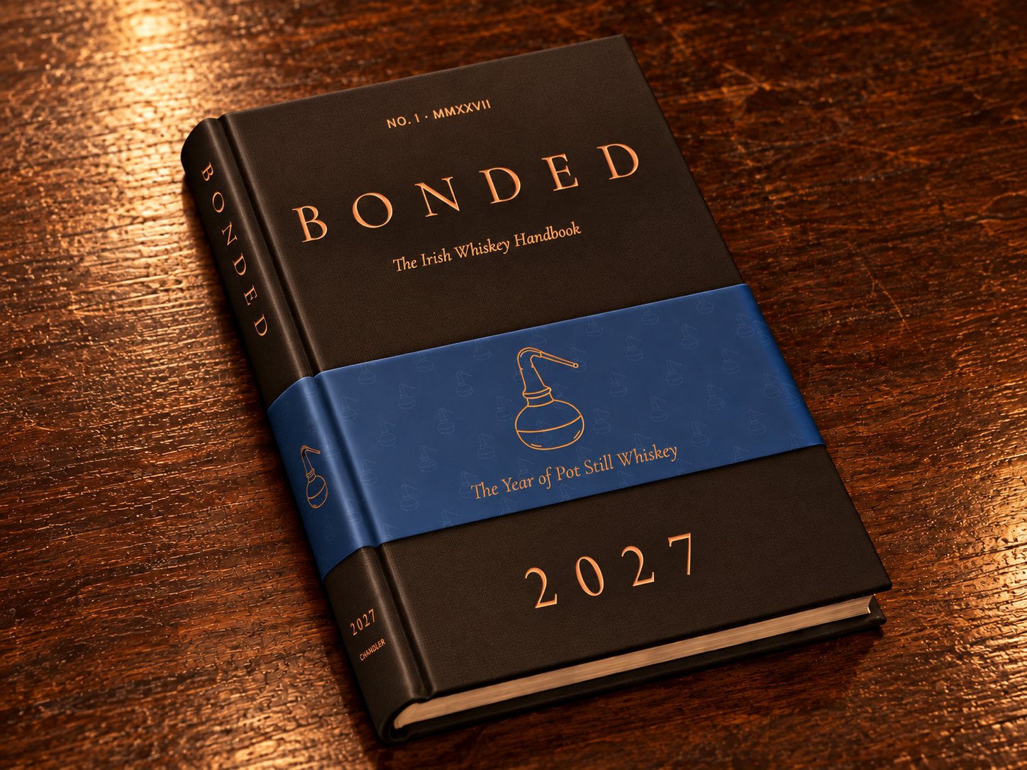 BONDED brown hardback with blue belly band on a wooden table