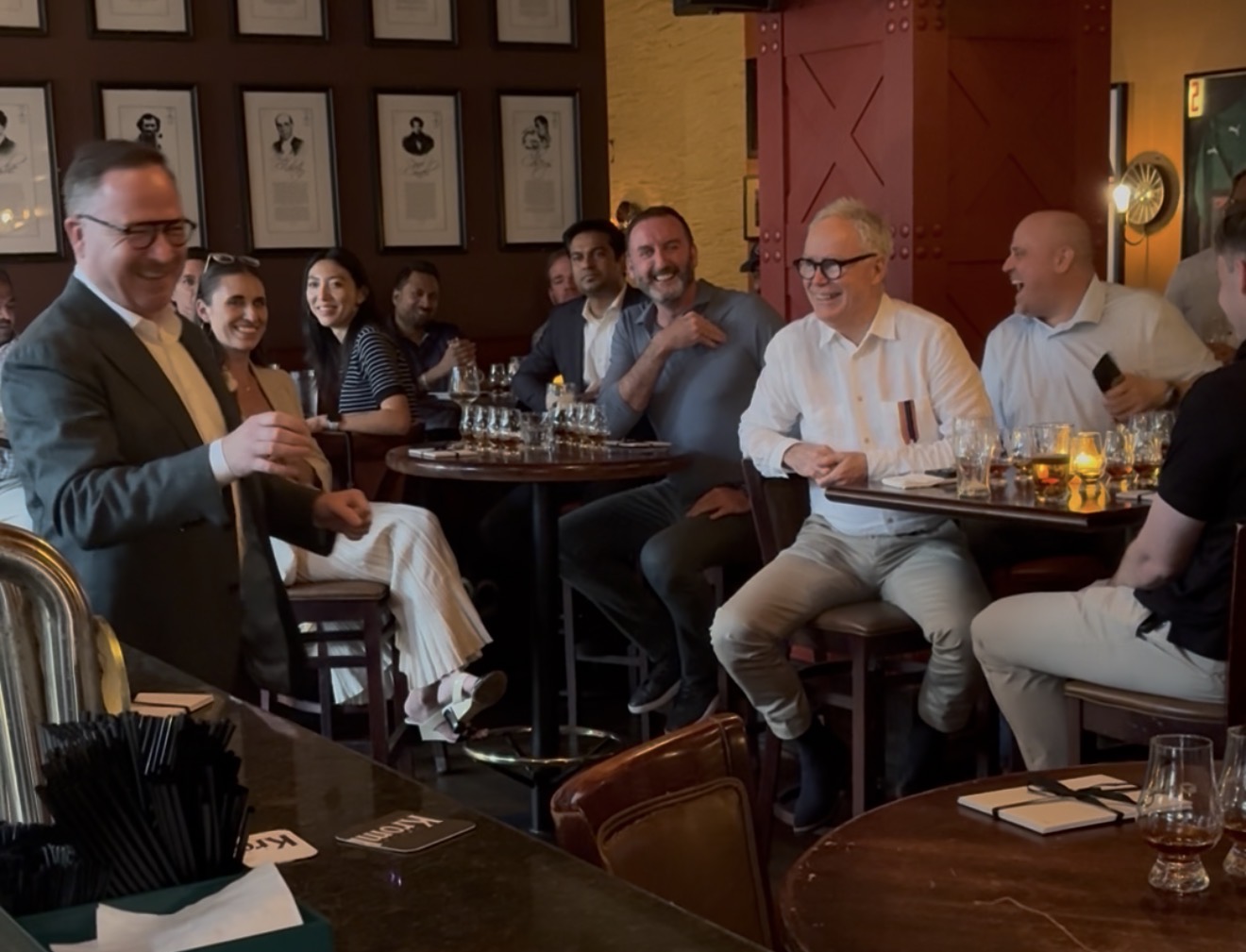 Barry Chandler sharing a laugh with guests while hosting a private whiskey tasting